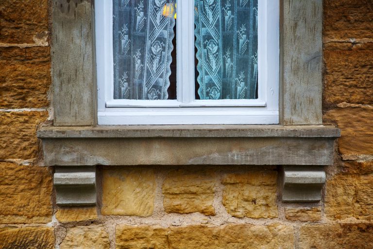exterior view of a window  at a stone house hogyan készítsünk műkövet